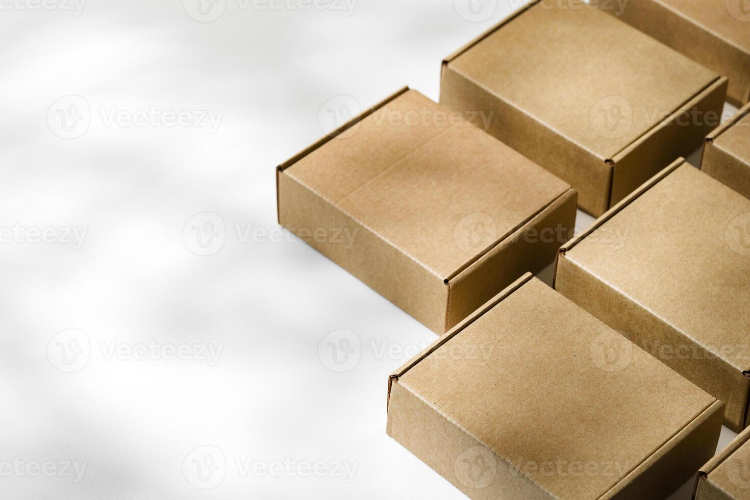 Brown cardboard boxes arranged on a neutral background in a warehouse setting during daylight hours photo