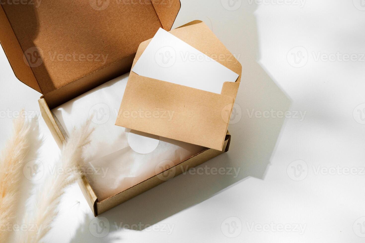 Delivery package with a blank envelope and decorative elements on a light background photo