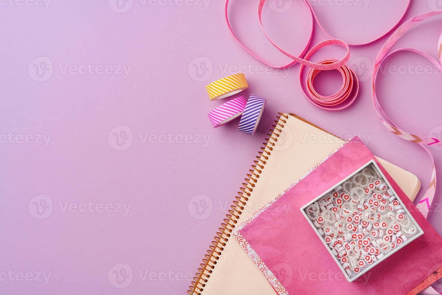 Crafting supplies on a purple background ready for creative projects photo
