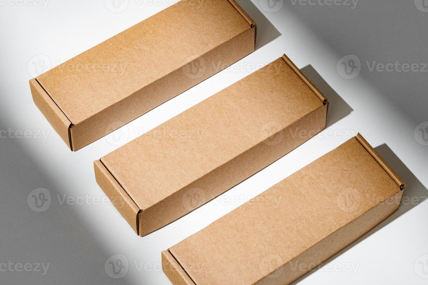Freshly packed cardboard boxes resting on a white surface, illuminated by soft natural light photo