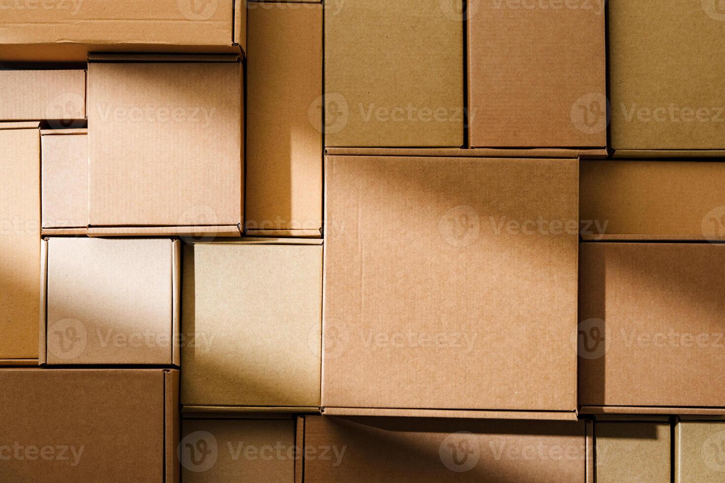 Stacked cardboard boxes arranged in a neat pattern under natural light photo