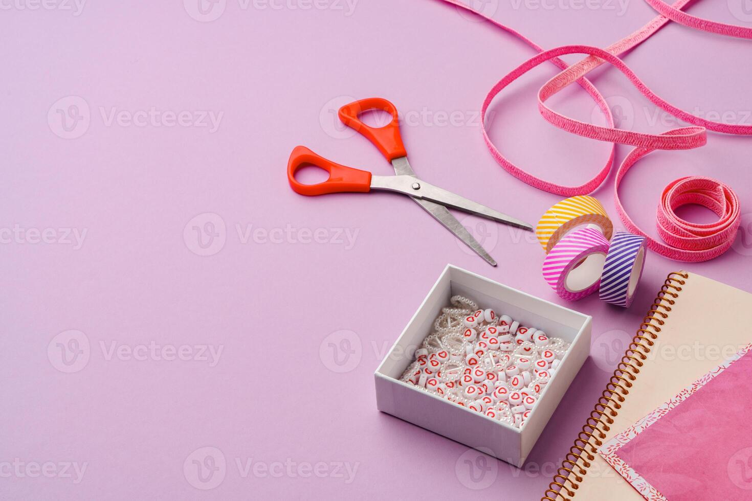 Crafting supplies on a purple background ready for creative projects photo