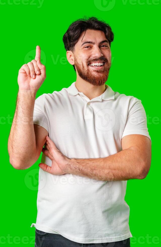 Man with a beard smiling and raising finger in a bright green studio photo