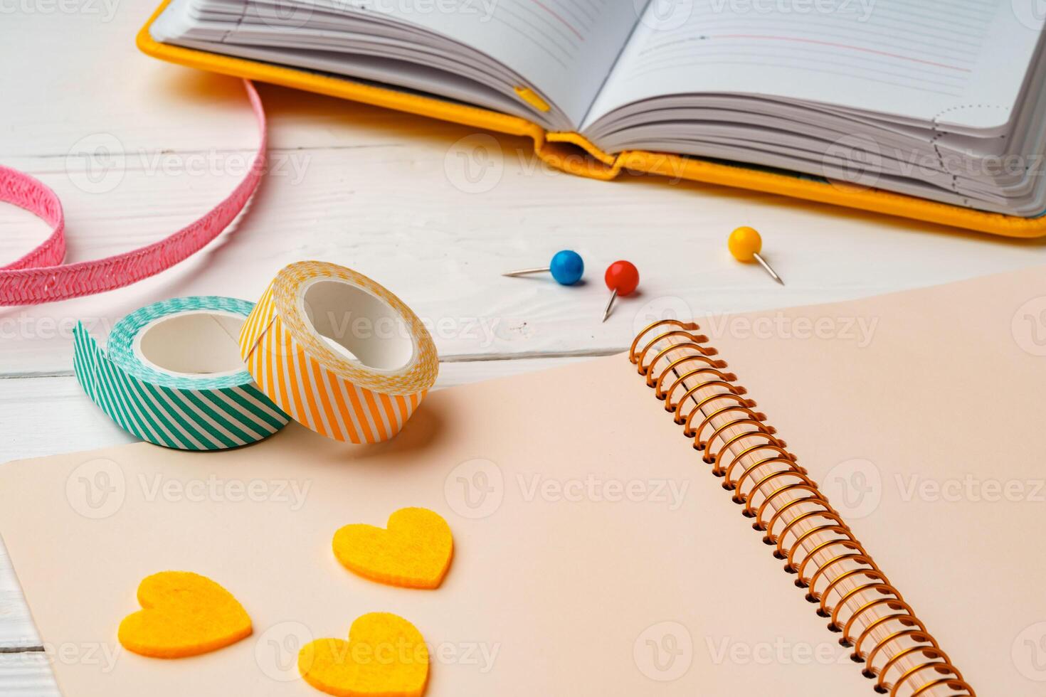 Creative workspace with colorful stationery and decorations on a white wooden desk photo