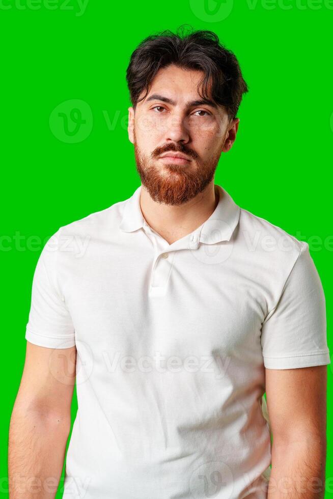 A man with a serious expression stands against a vibrant green background photo