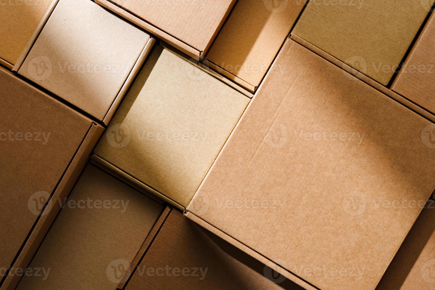 Stacked cardboard boxes arranged in a neat pattern under natural light photo