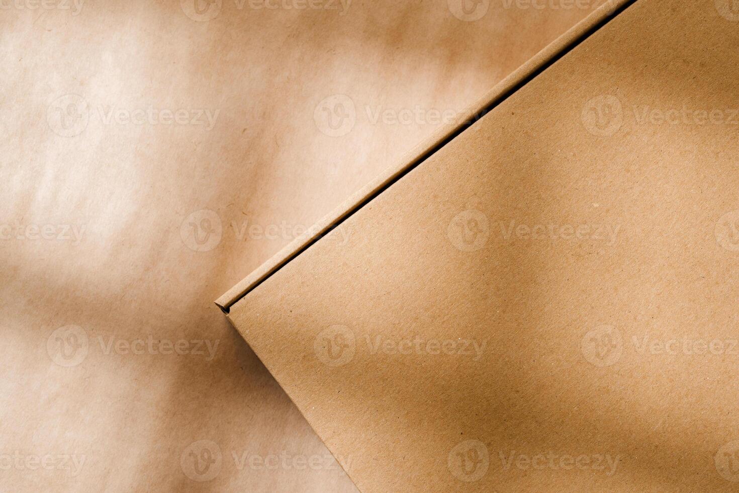A plain cardboard box on a textured surface with soft light and shadows during the afternoon photo
