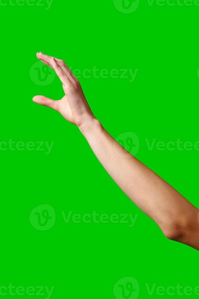 A womans hand extends upward into the air, fingers outstretched, reaching upward towards an unseen destination. photo