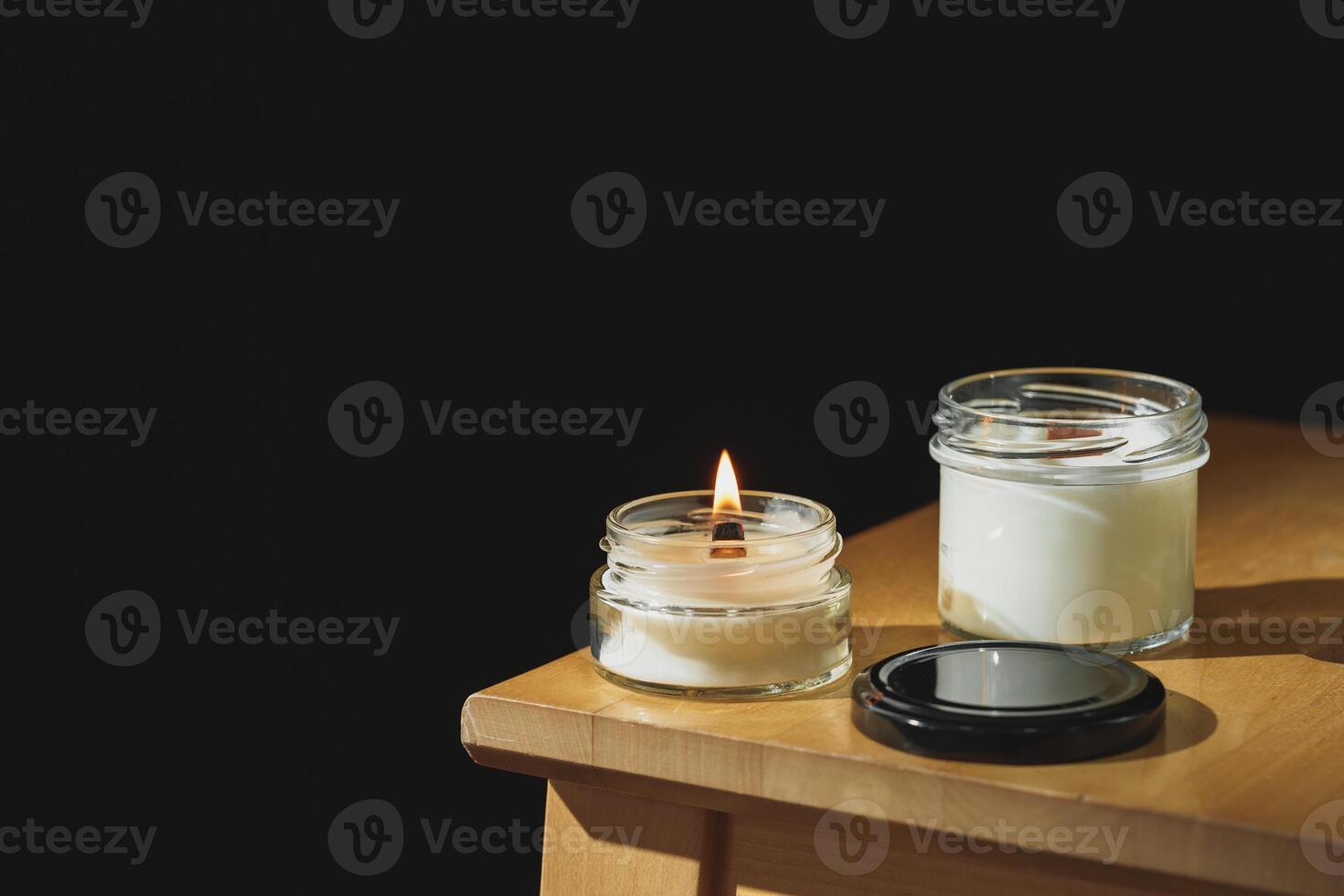 Serene Afternoon Ambiance With a Lit Scented Candle on a Wooden Nightstand photo