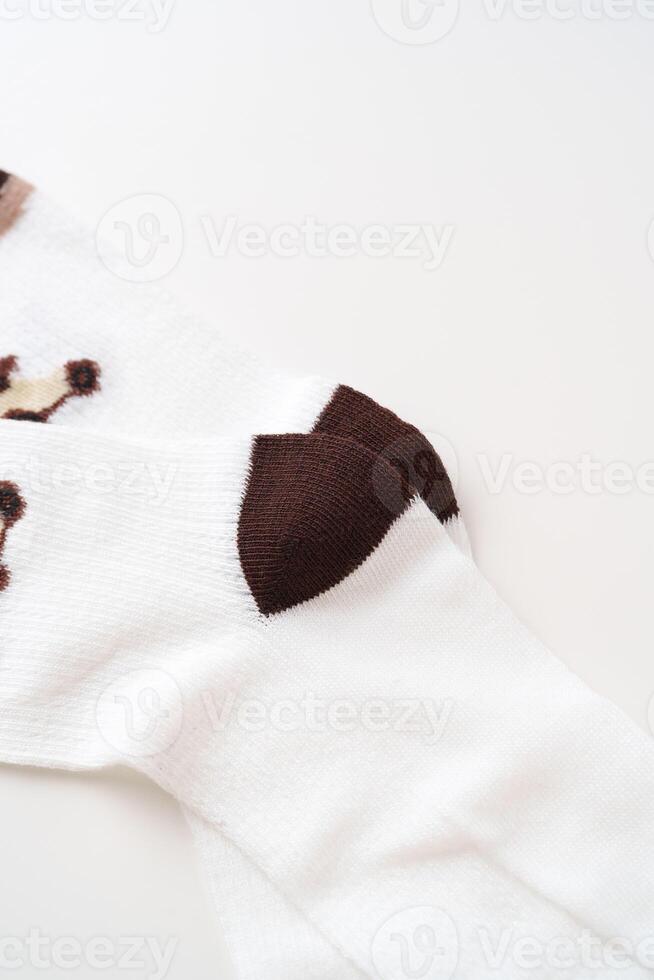 Blank white cotton sock with black heel on white background photo