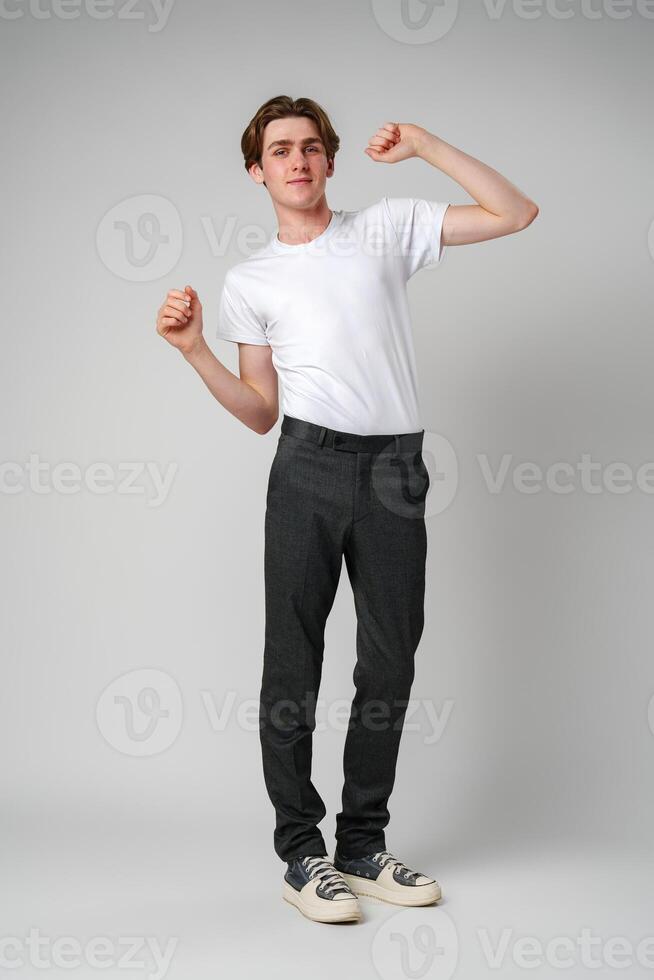 Young Man Dancing Alone in a Studio, Showing Off Casual Moves photo
