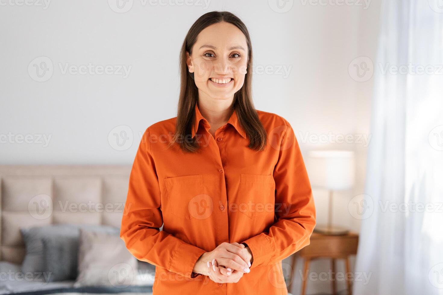 Portrait of cheerful, beautiful, smiling woman wearing casual outfit, looking at camera photo
