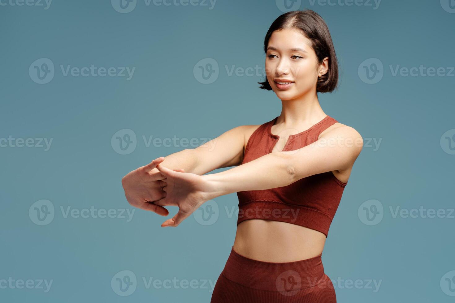 Portrait of positive attractive asian woman stretching standing isolated photo
