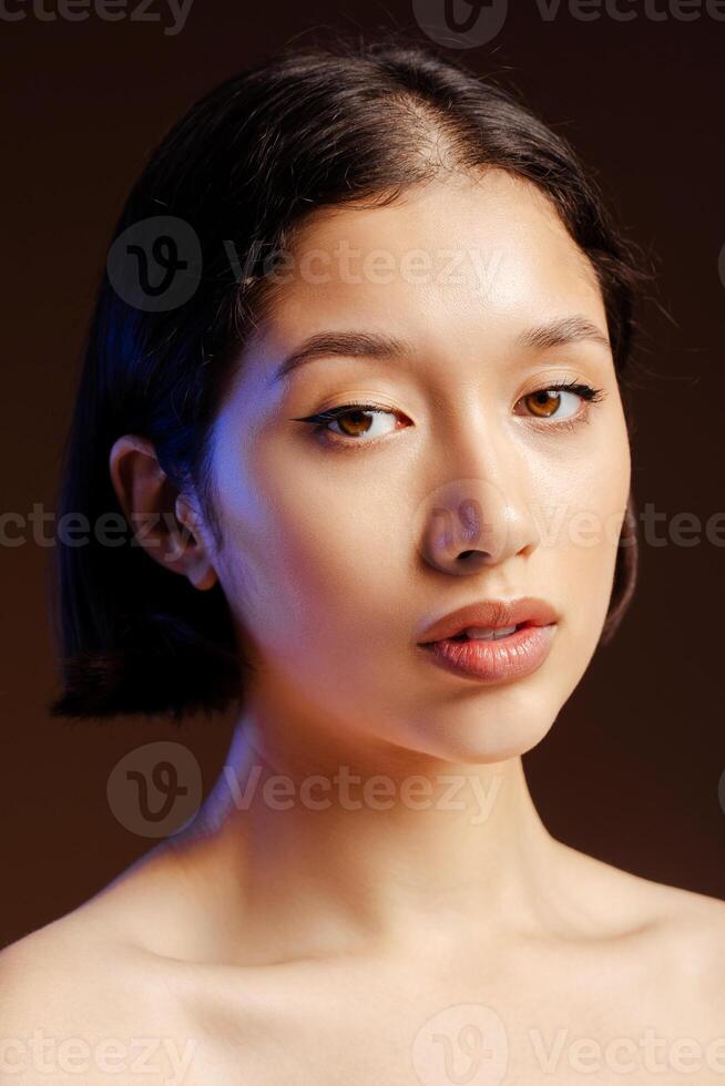 Closeup beauty portrait of dark-haired beautiful young woman, with fresh glowing healthy skin photo