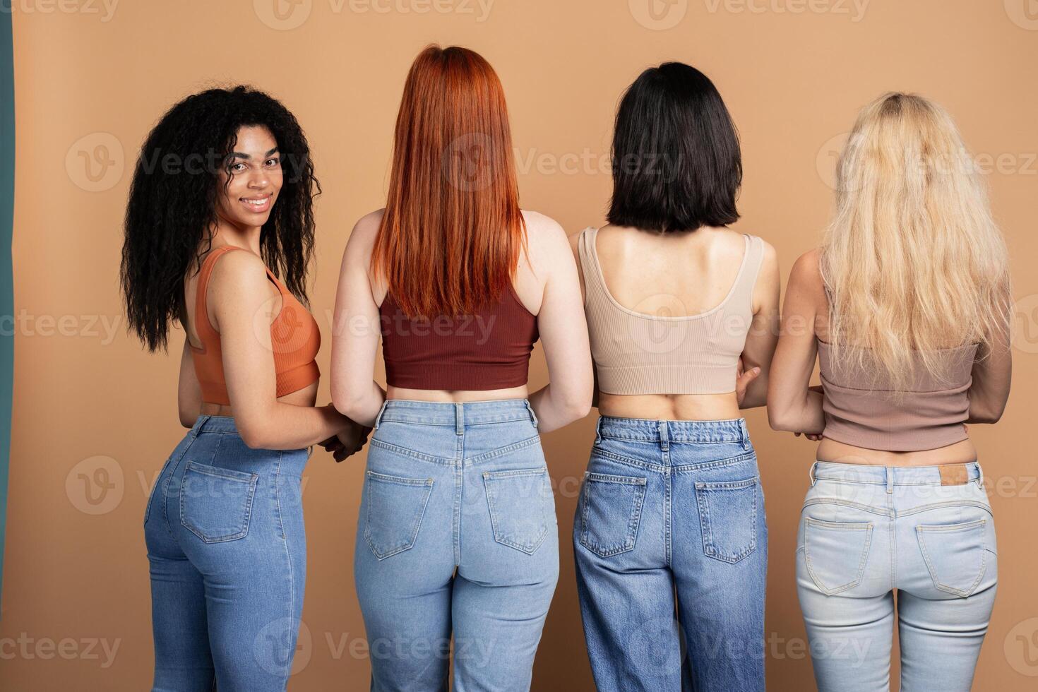 Diverse group of women posing in denim, rear view, African American woman photo