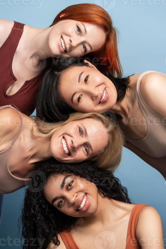 Portrait of smiling diverse women smiling and supporting each other, posing, looking at camera photo