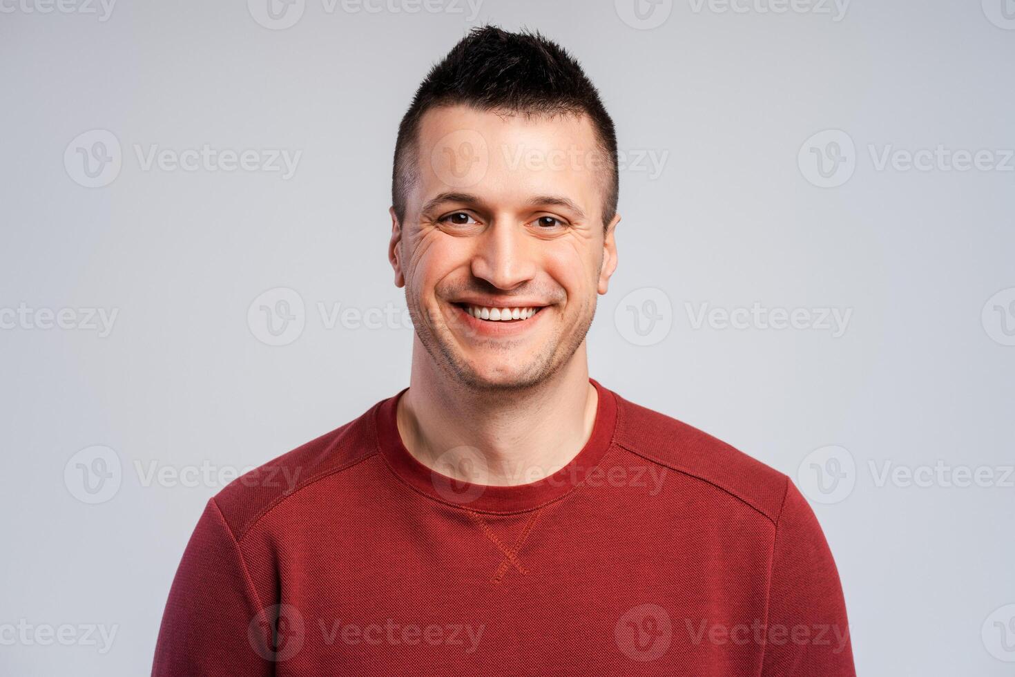 Smiling confident middle aged man standing isolated on gray background looking at camera photo