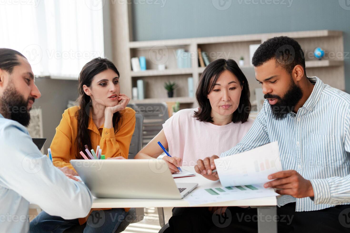 Marketing team analyzing financial data and brainstorming on project photo