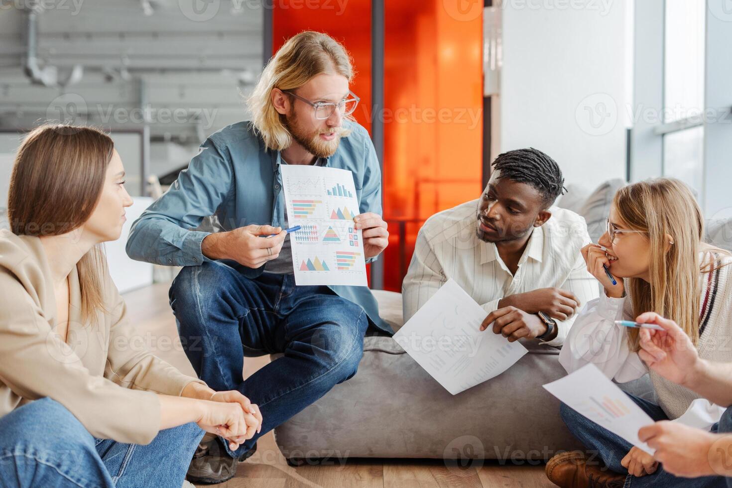 Marketing team discussing financial charts during brainstorming session photo