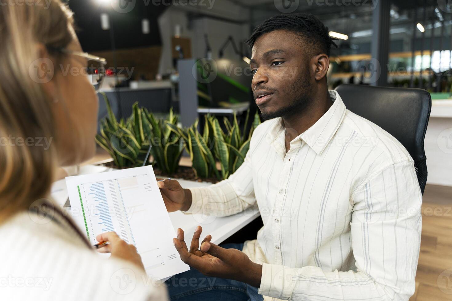 Business people having meeting analyzing financial documents using graphs photo