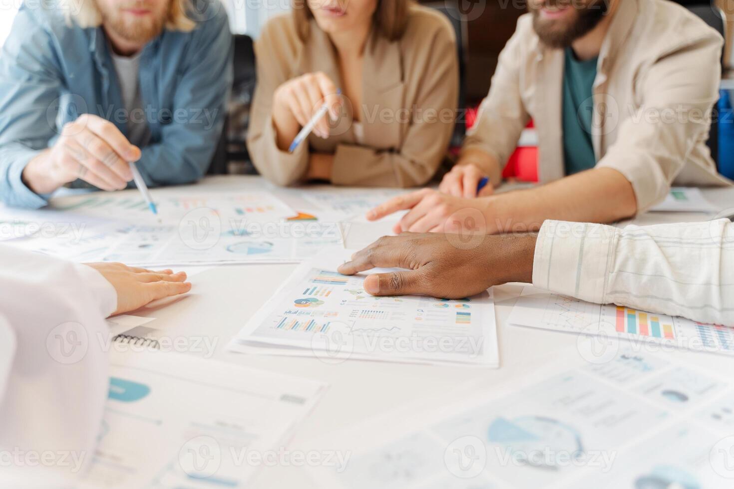 Diverse group of professionals analyzing financial data in a business meeting photo