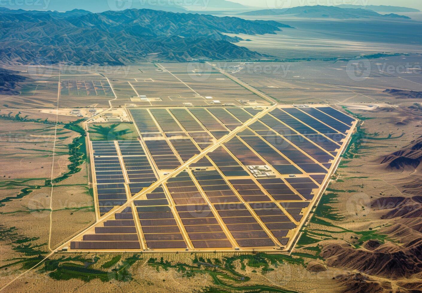 Aerial view of a sprawling solar farm with rows of panels absorbing sunlight in the desert photo