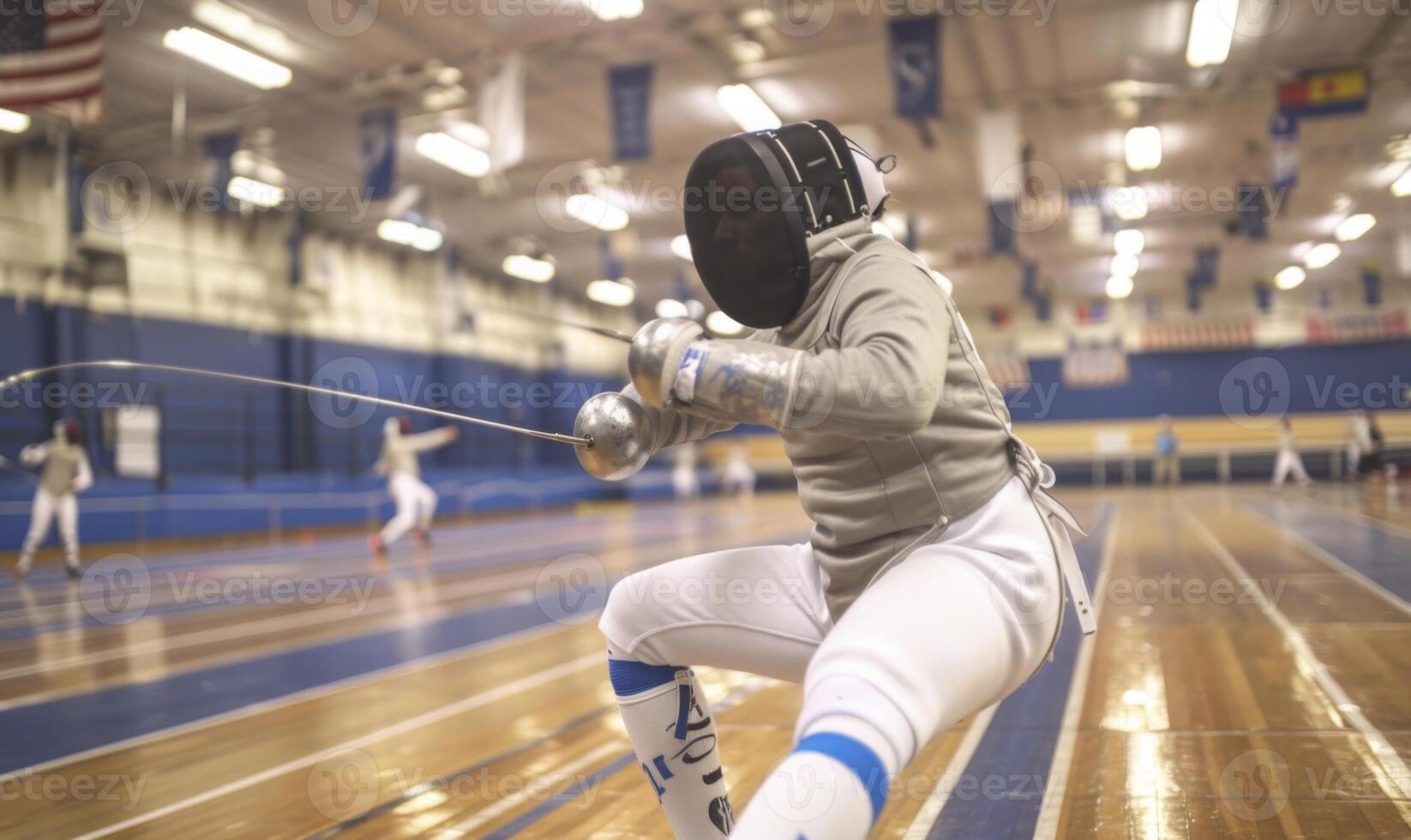 A fencer's body in action, with the opponent and fencing area in the background photo