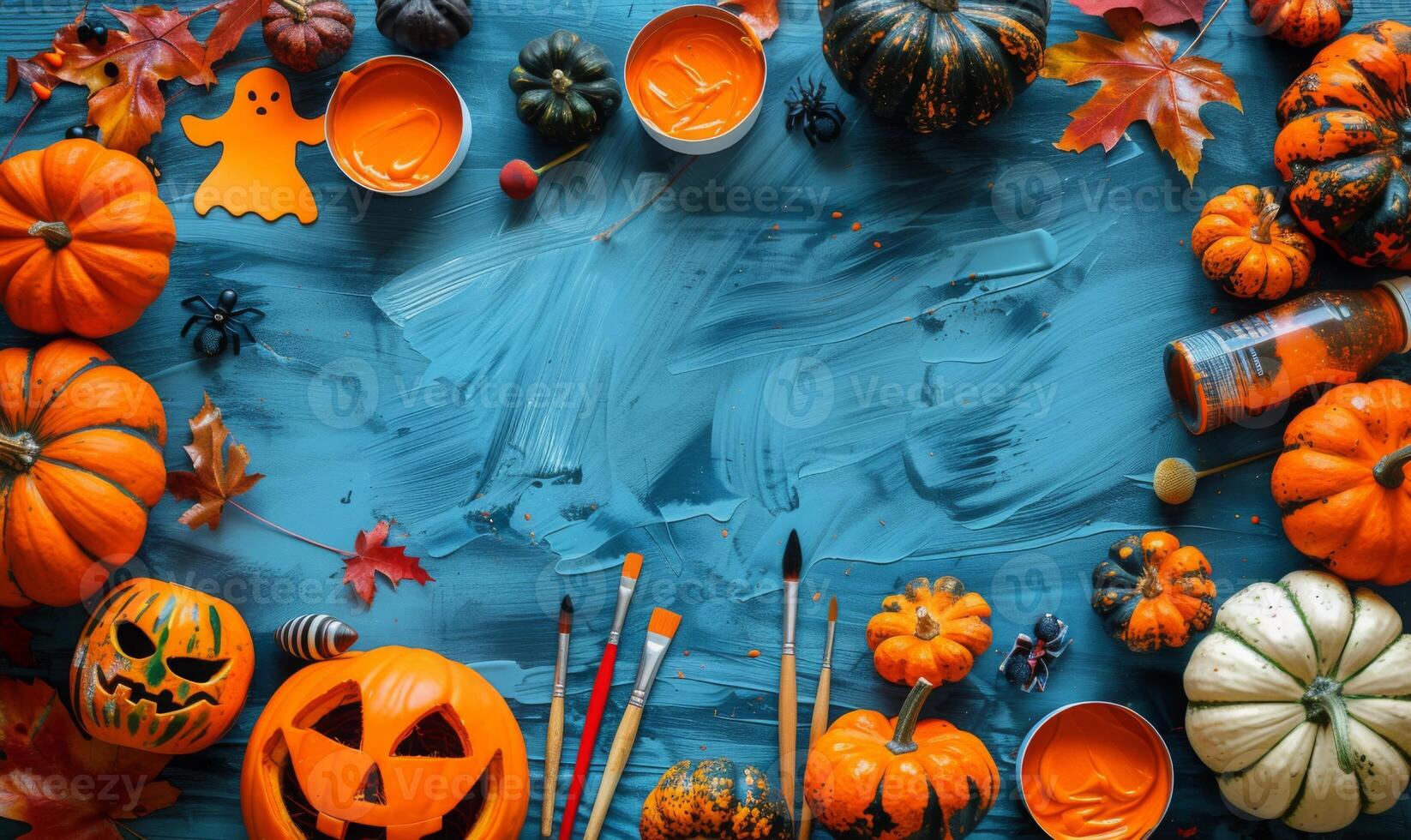 A flat lay featuring Halloween crafts like carved pumpkins, ghost cutouts, and paintbrushes, with an open area for text photo