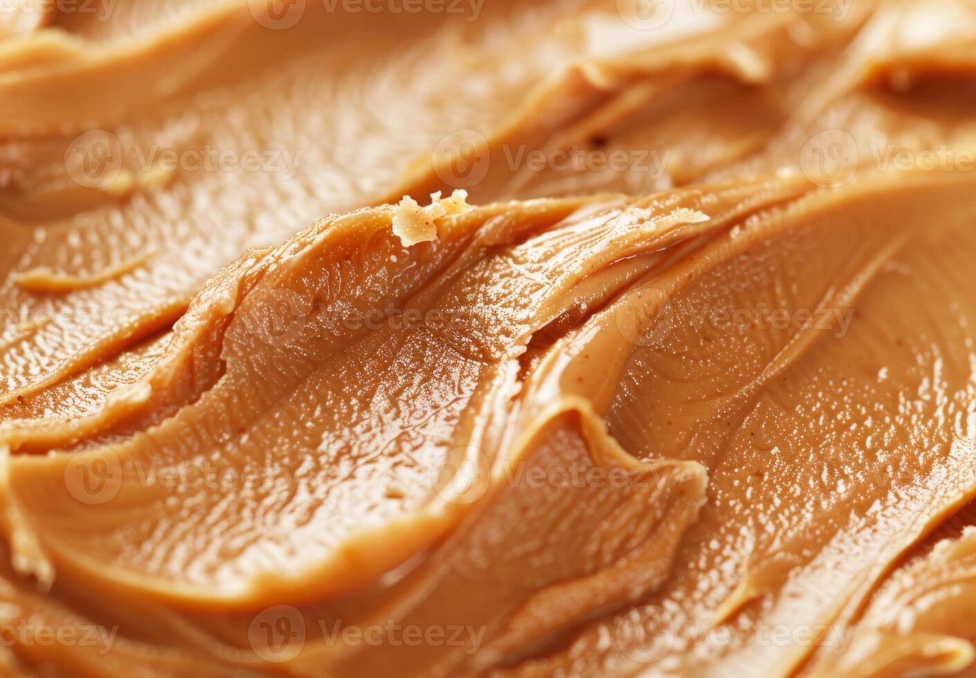 High-detail close-up of the smooth and creamy texture of peanut butter photo