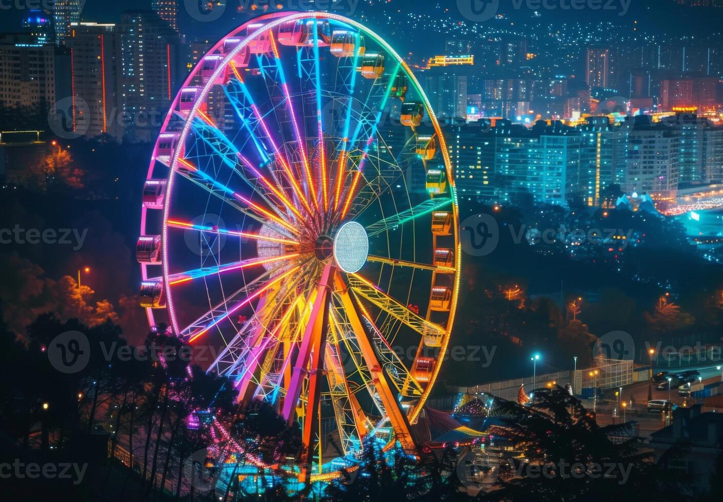 A ferris wheel is lit up at night with a city in the background photo