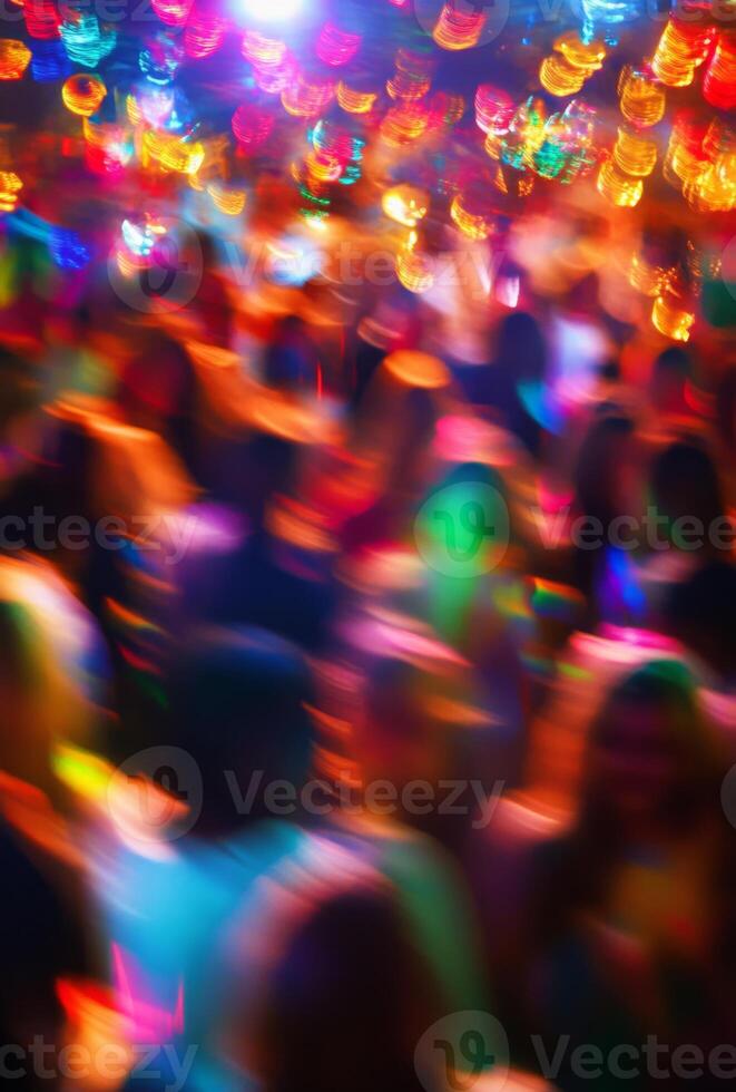 A blurry image of people dancing at a party photo