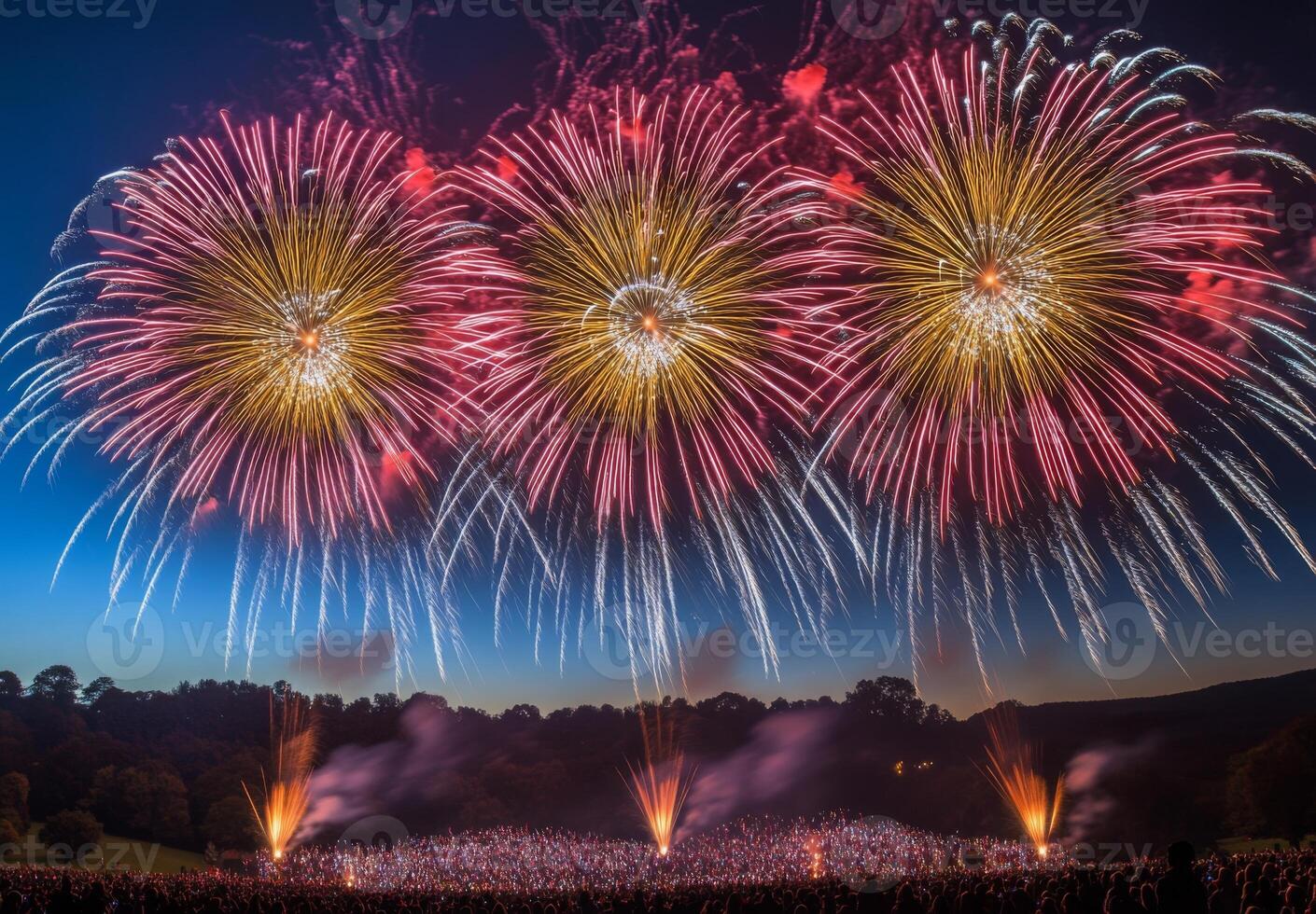 Colorful fireworks lighting up the sky with large bursts, silhouetting a cheering crowd below photo