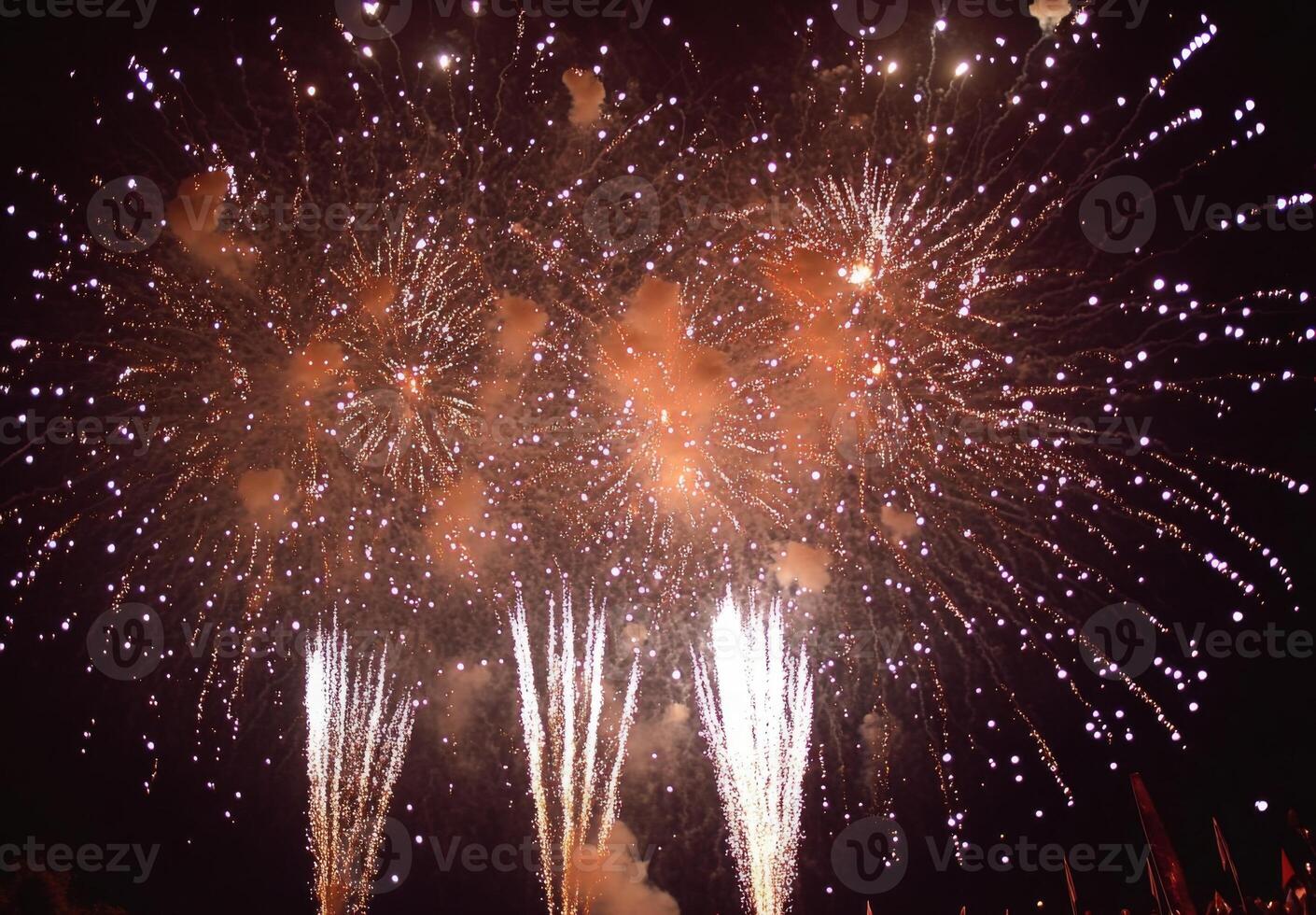Fireworks bursting in the sky above a festive celebration, with shimmering sparks falling gracefully photo
