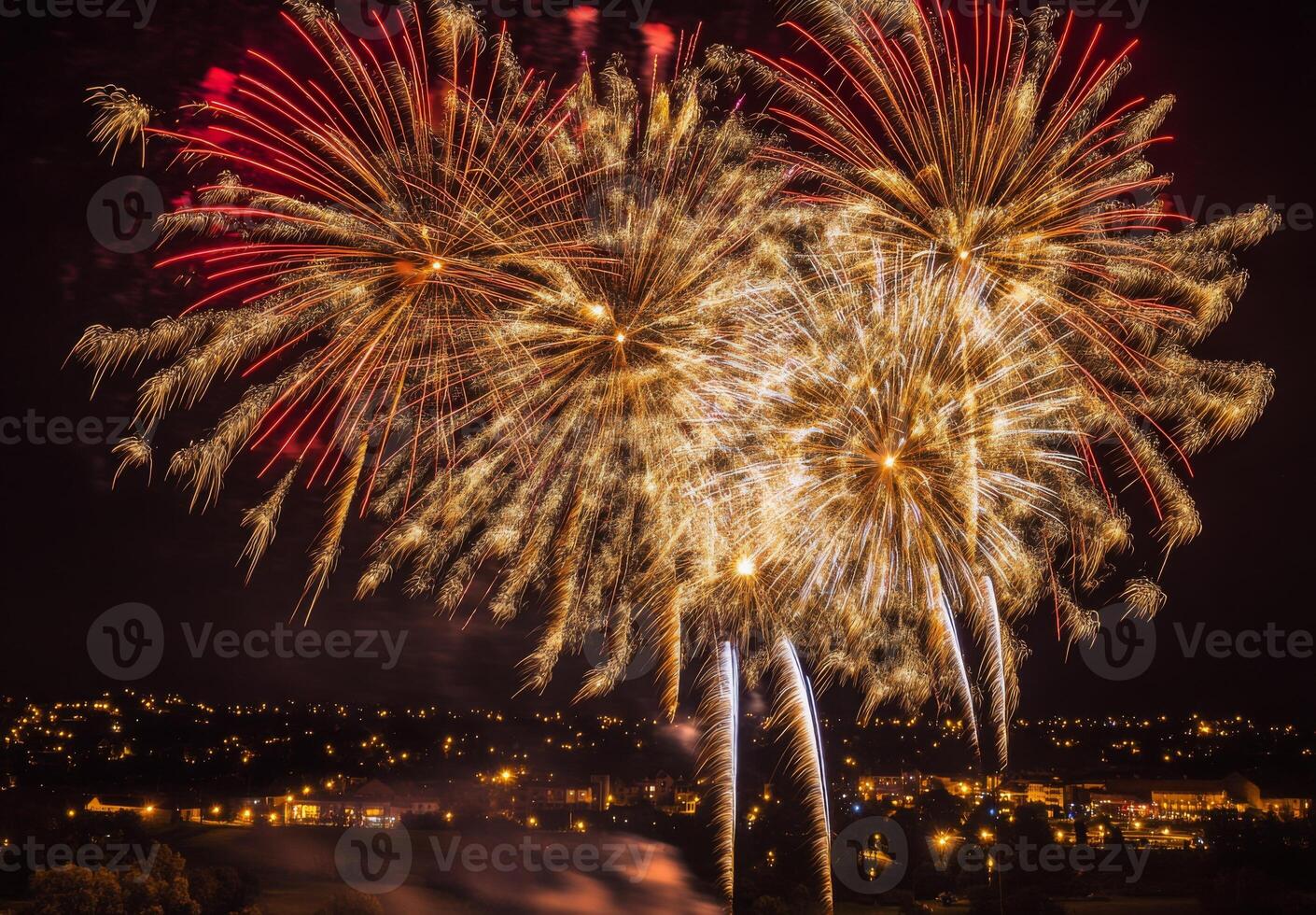 Golden and red fireworks spreading across the sky, with city lights twinkling in the background photo