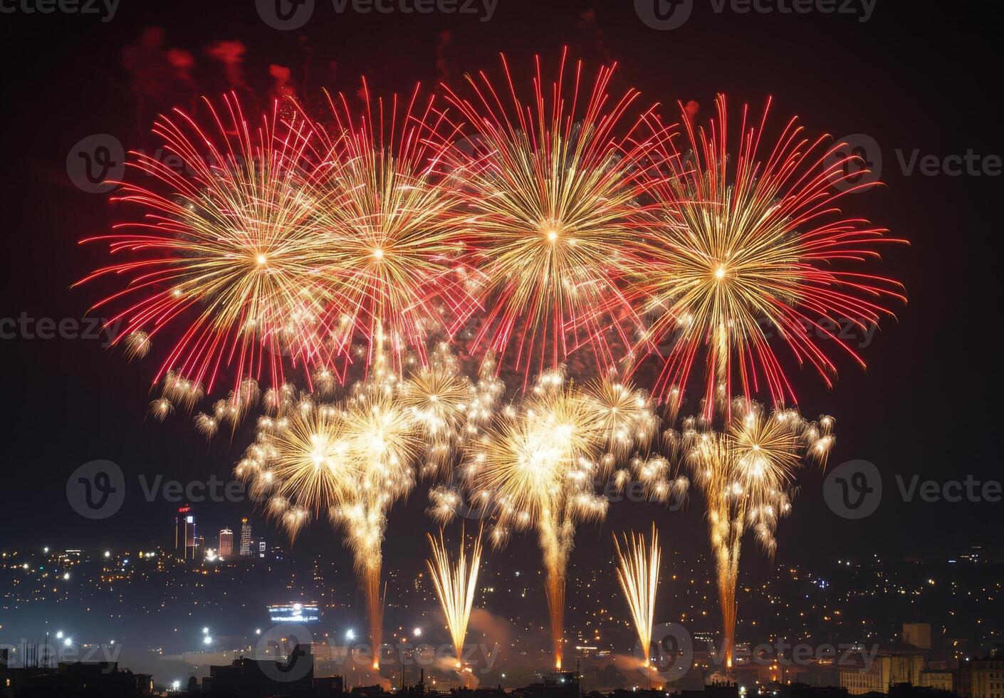 Golden and red fireworks spreading across the sky, with city lights twinkling in the background photo