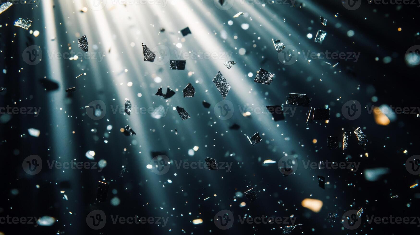 A cascade of metallic confetti falling in slow motion, with radiant beams of light piercing through the darkness, highlighting each piece in vivid detail photo