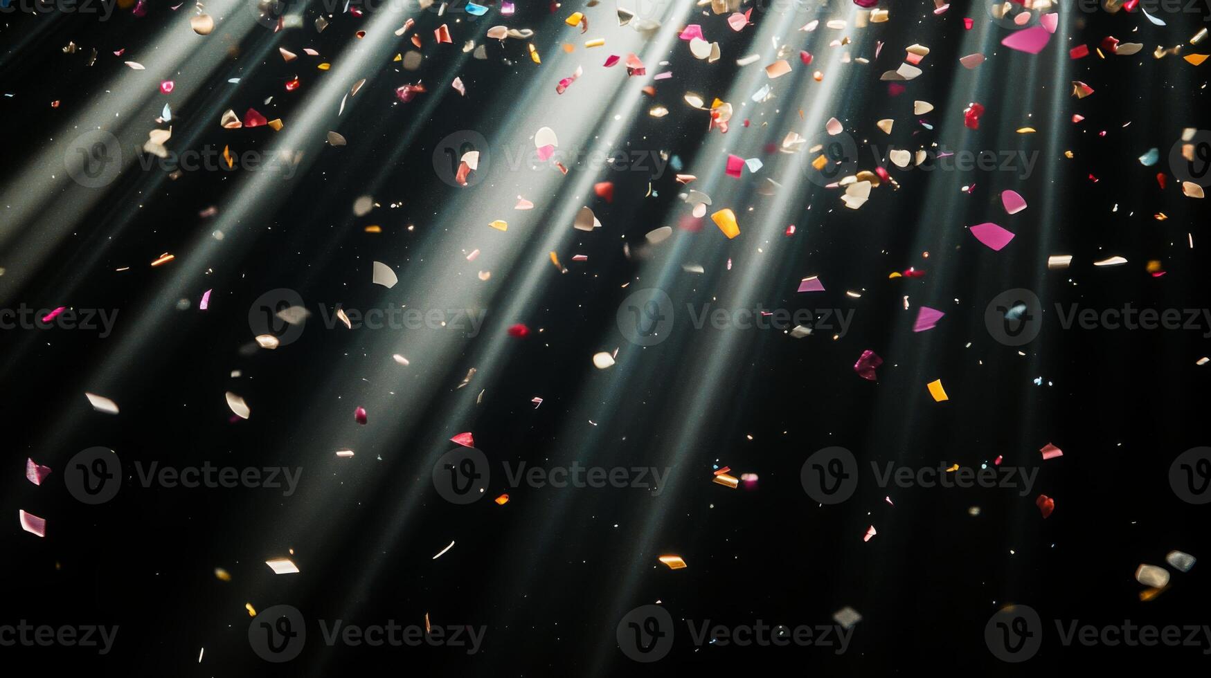 Abstract image of falling confetti illuminated by soft, scattered light rays, creating a magical and ethereal atmosphere over a black background photo