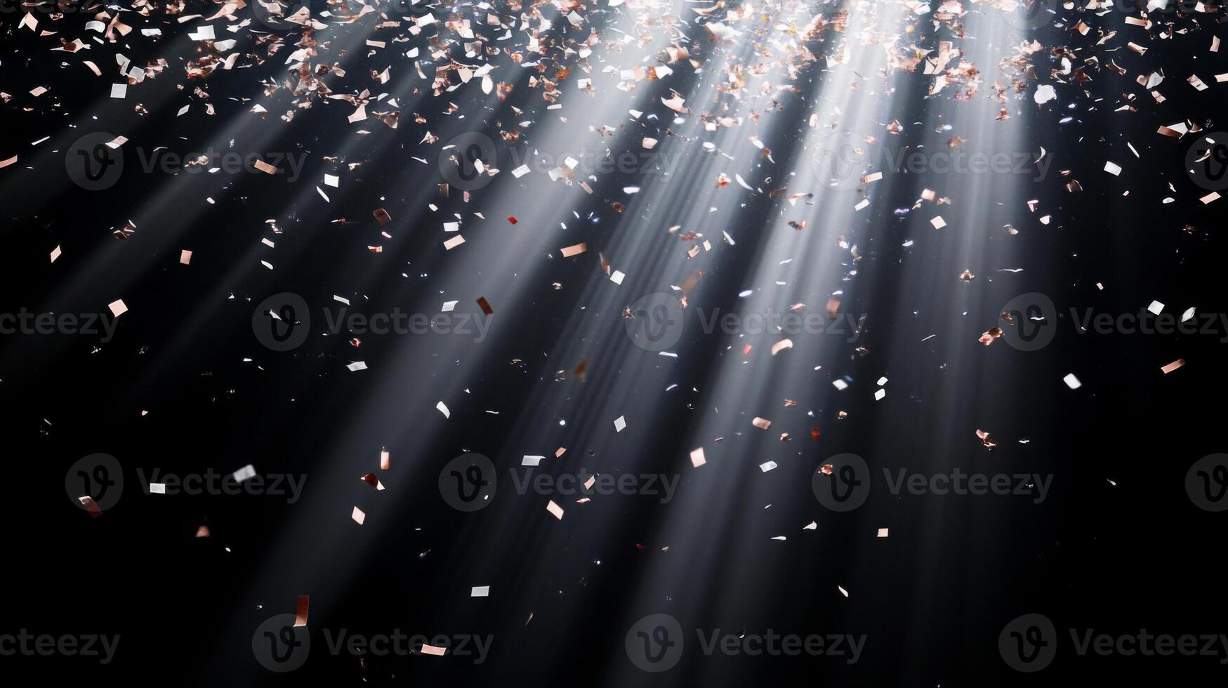 Abstract image of falling confetti illuminated by soft, scattered light rays, creating a magical and ethereal atmosphere over a black background photo