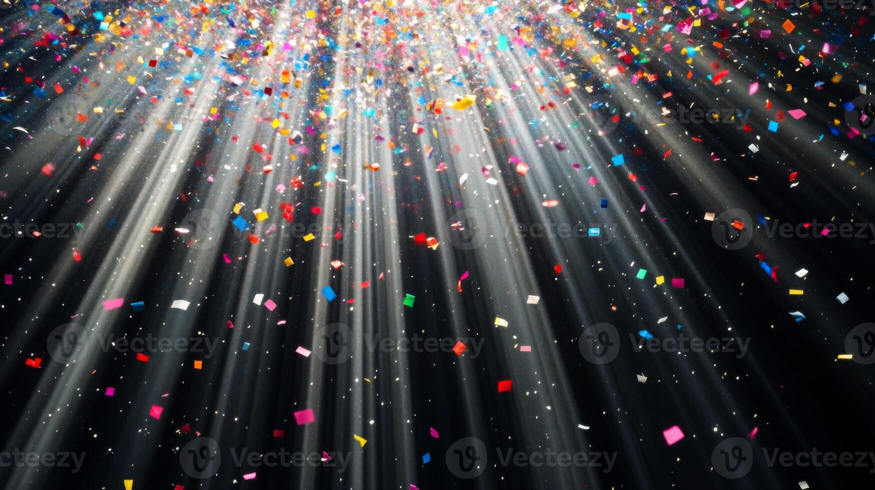 Colorful confetti suspended mid-air, with beams of light fanning out and illuminating the particles as they fall against a black void photo