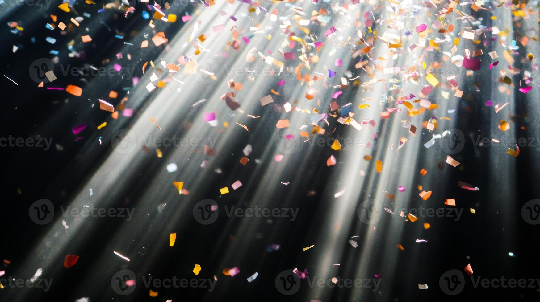 Soft, multicolored confetti drifting through shafts of light, with the dark background creating a stark, captivating contrast photo