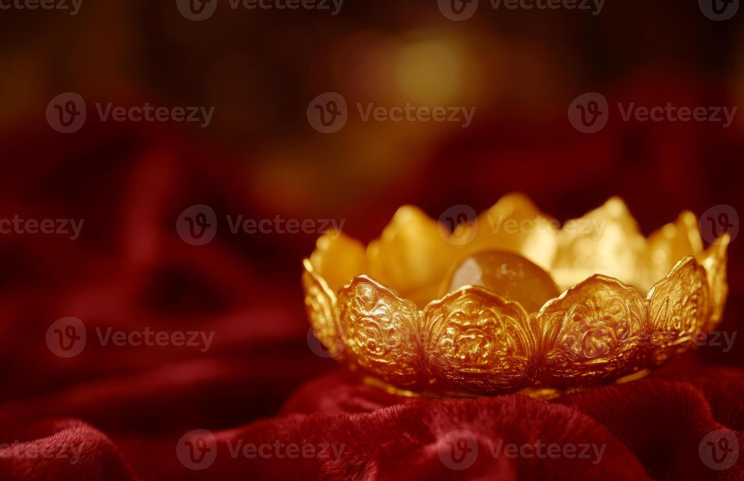 Golden lotus flower candle on red cloth photo