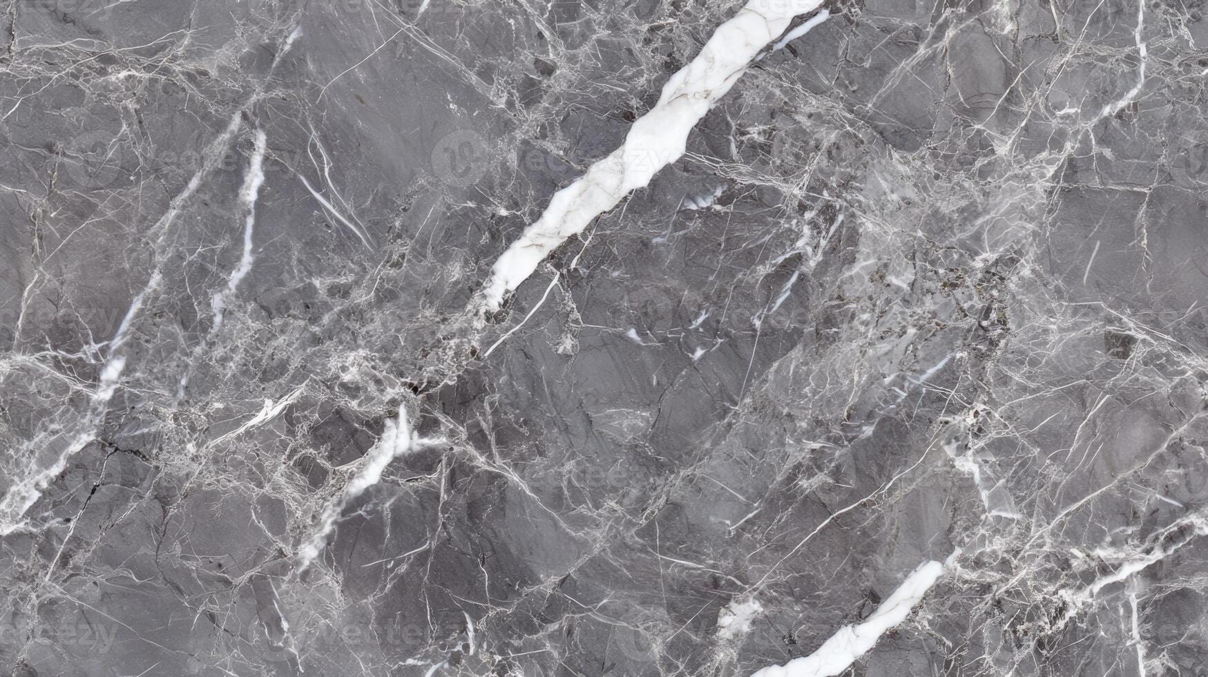 A close-up top view of polished grey marble with soft white veining, filling the frame with a sleek and contemporary texture photo
