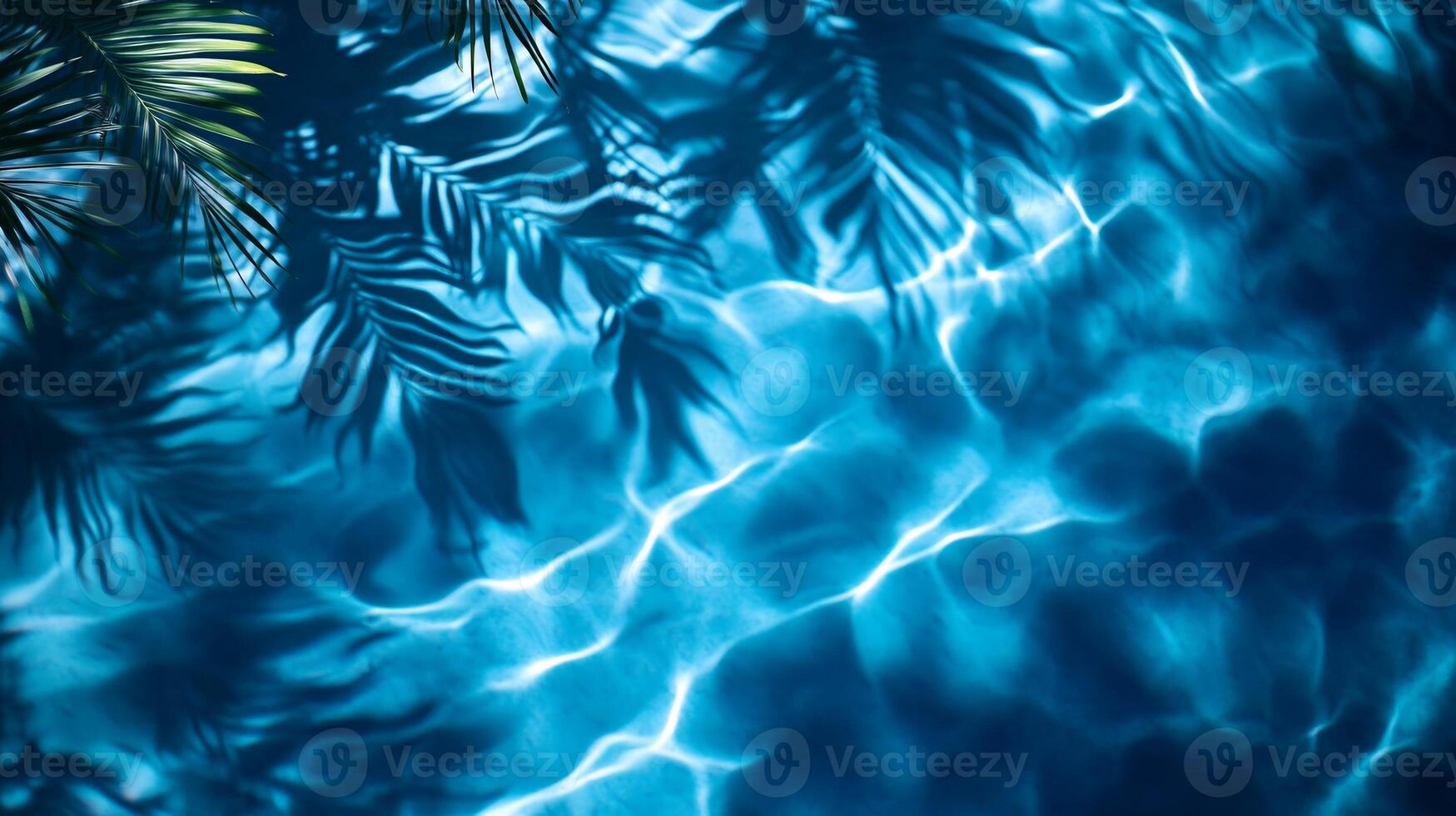 Abstract aqua wave patterns with blurred tropical leaf shadows swaying on a deep blue water texture photo