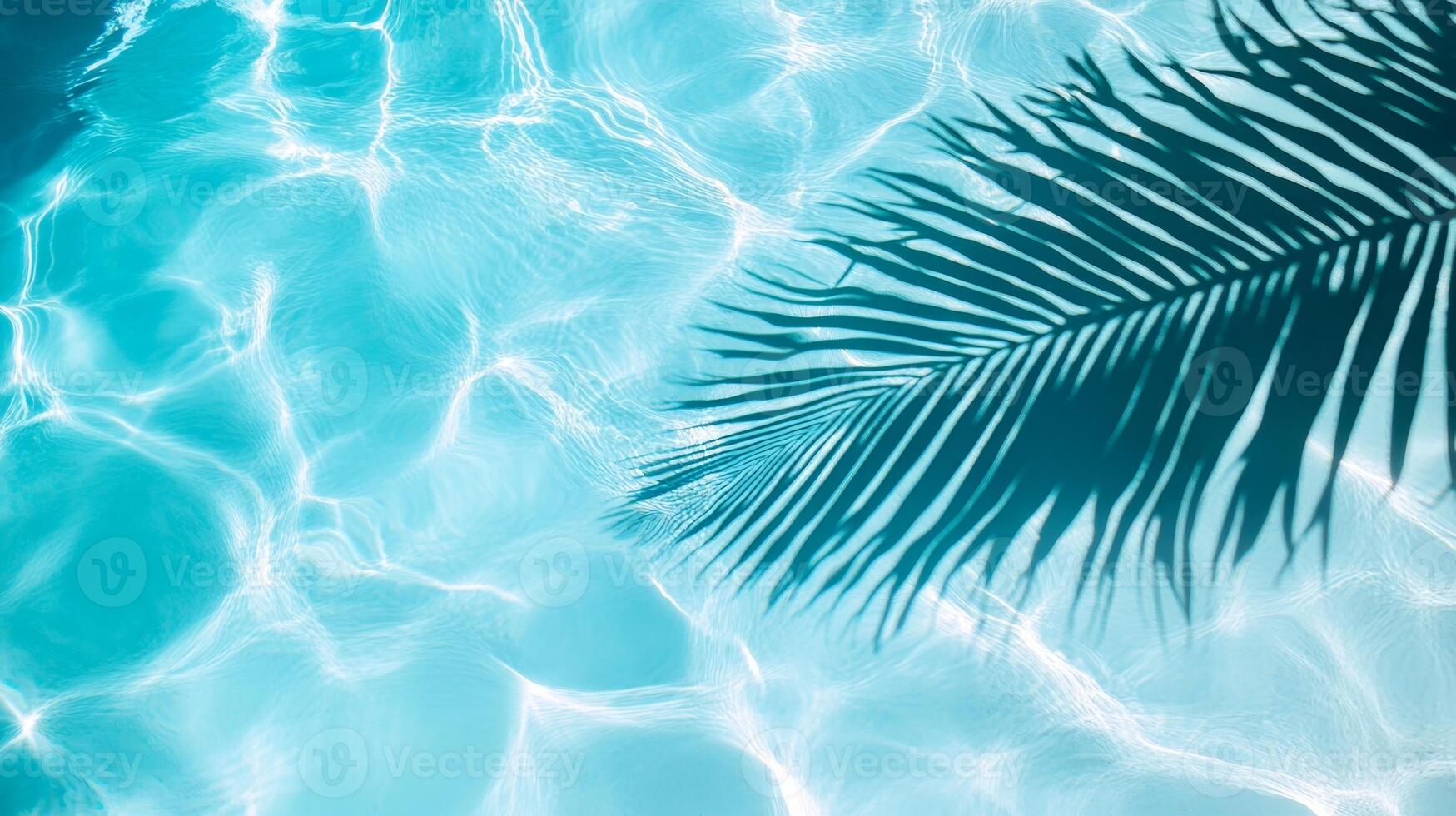 Smooth waves with a palm leaf shadow, creating a tranquil tropical atmosphere on a clear blue pool surface photo