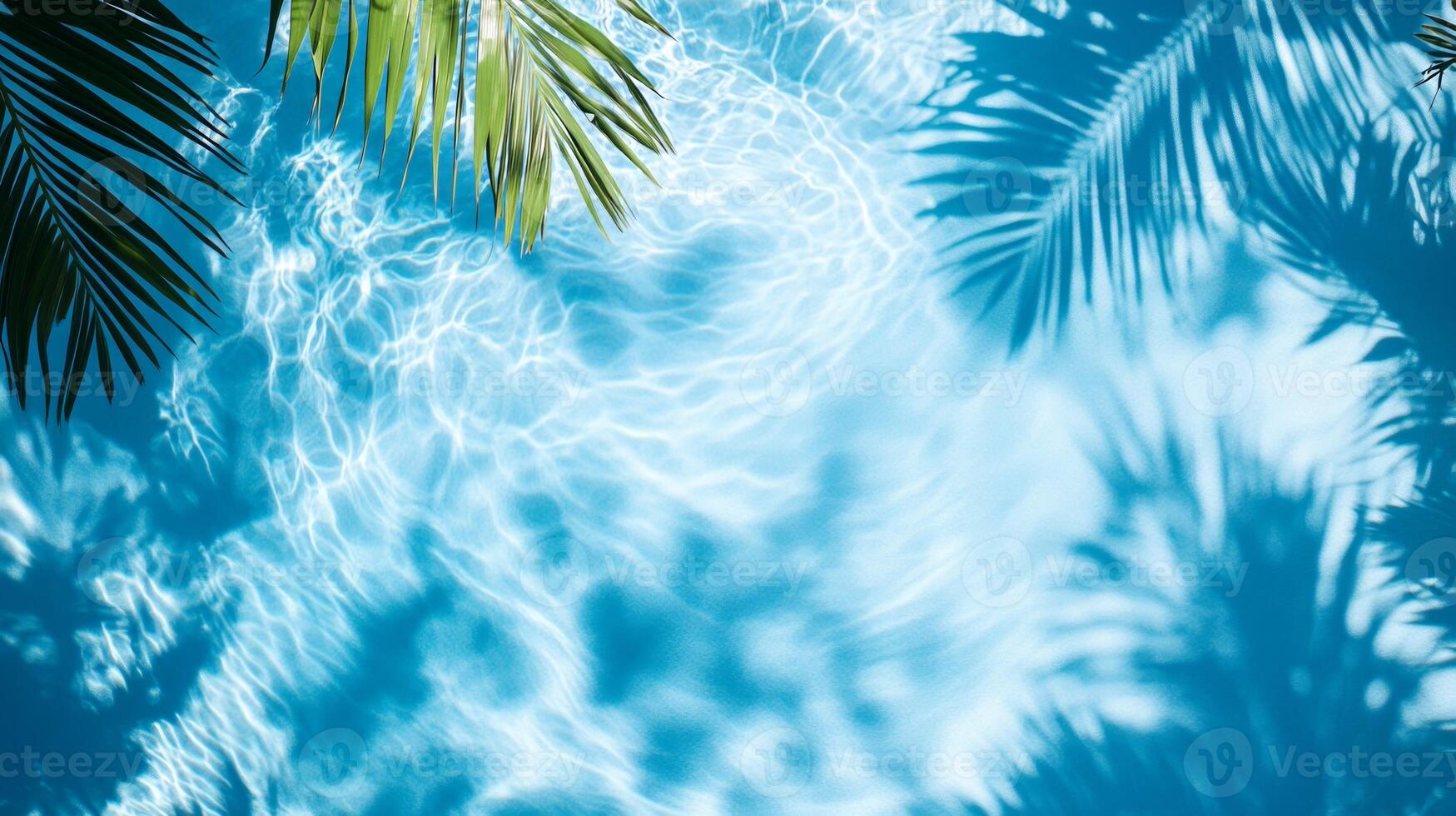 Top view of a crystal blue pool, with layered shadows of tropical foliage on the gentle wave texture photo