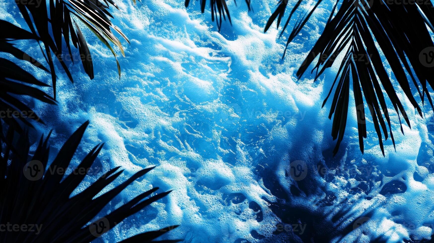A dynamic water texture of blue waves, with sharp tropical leaf shadows enhancing the visual effect photo