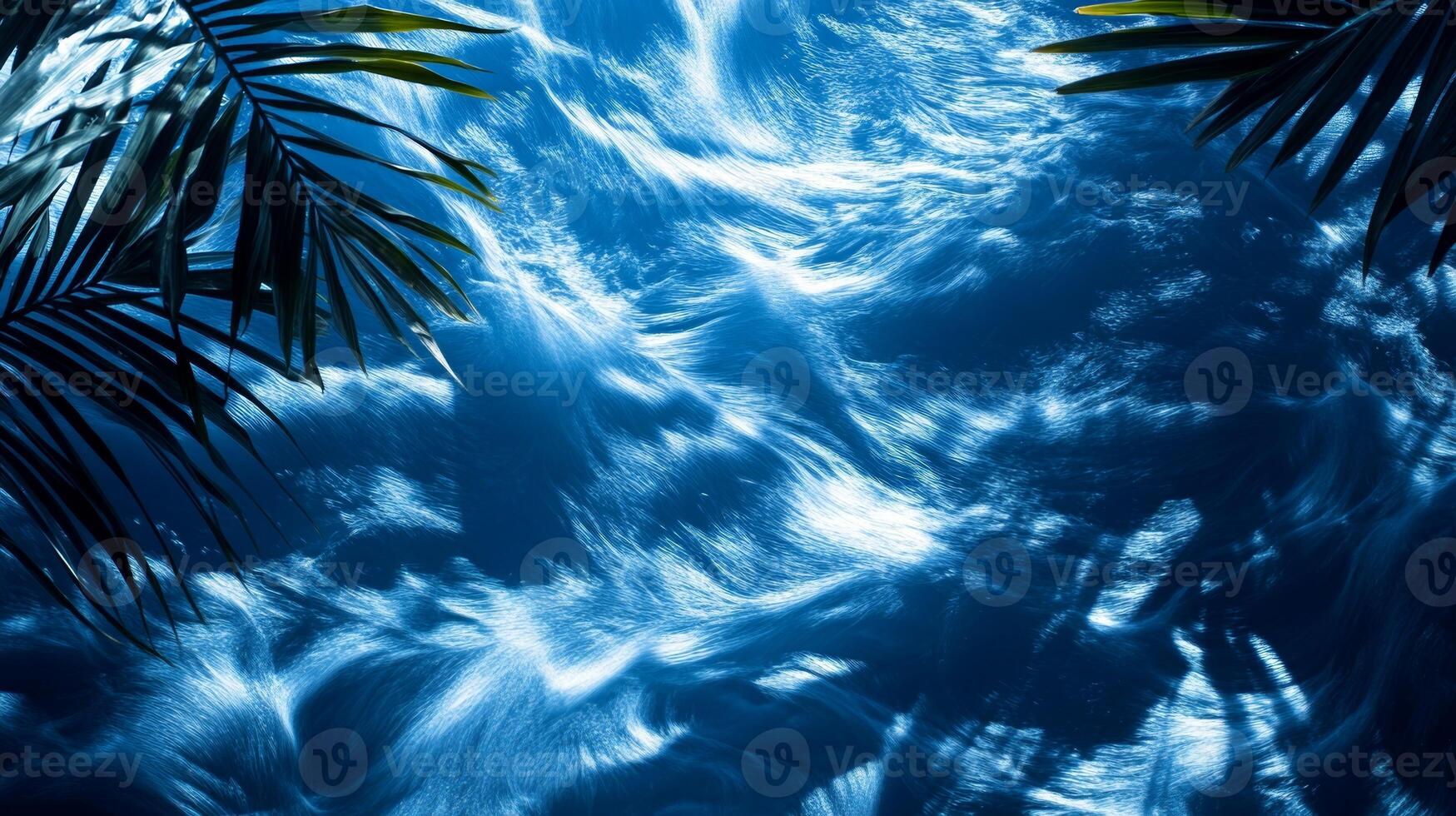A dynamic water texture of blue waves, with sharp tropical leaf shadows enhancing the visual effect photo