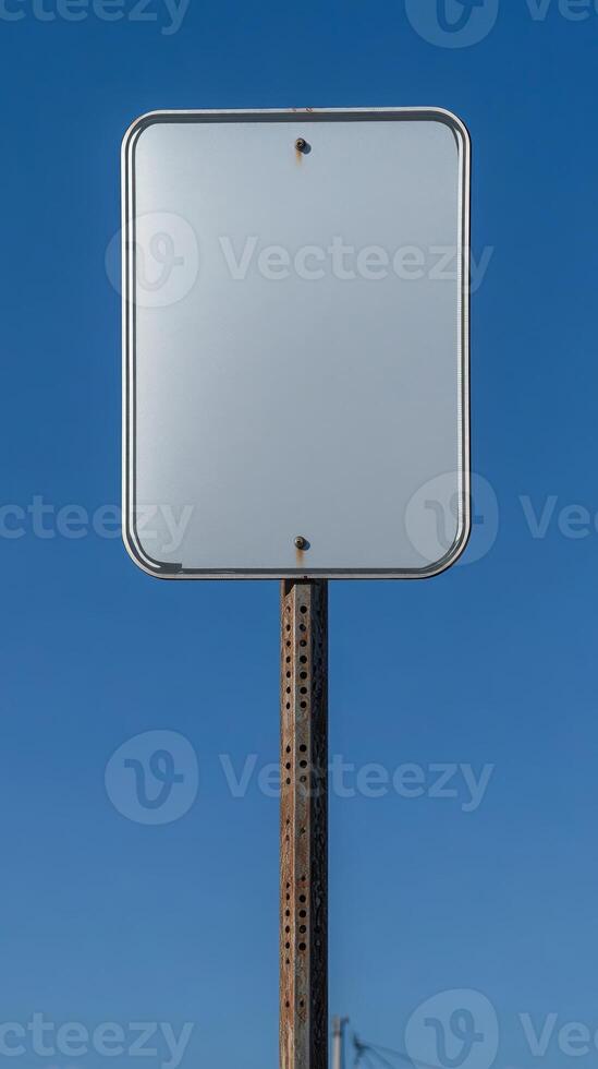 Closeup of a blank rectangular road sign on a tall post, ready for custom text photo