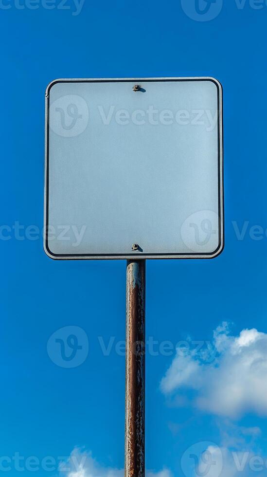Closeup of a blank rectangular road sign on a tall post, ready for custom text photo