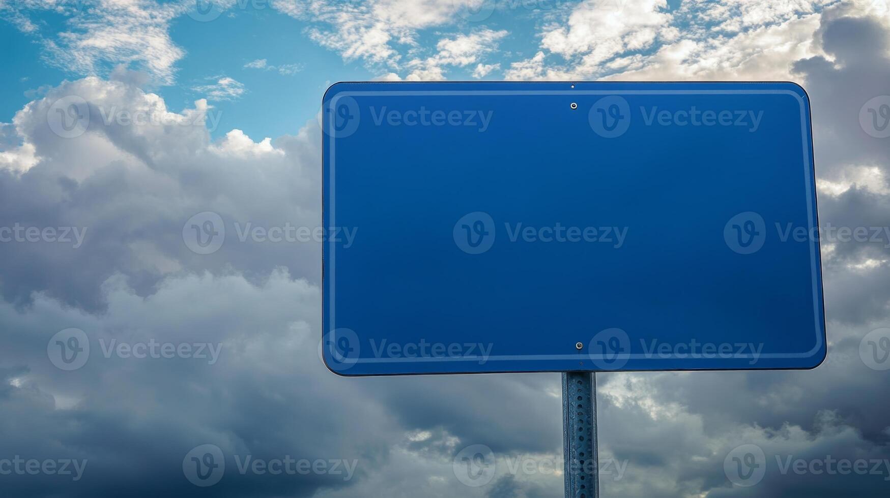 Closeup of a plain blue road sign with no text, isolated against a cloudy sky for mockup purposes photo